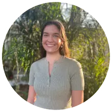 Danielle Ballinger, Master's Level Student at Sunshine State Counseling Center, smiling outdoors with greenery in the background.