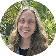Madison Hamilton, Master's Level Student at Sunshine State Counseling Center, smiling in front of tropical foliage.